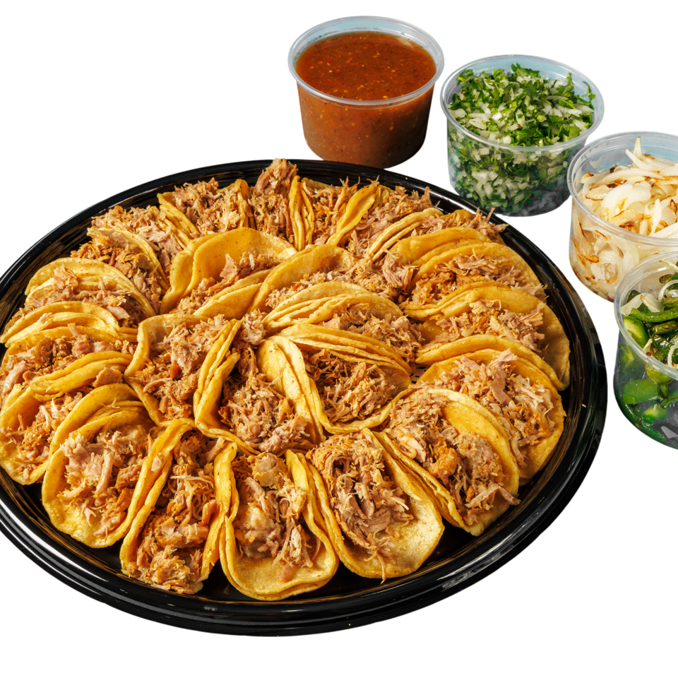 Large platter of shredded-meat tacos served with red salsa, chopped cilantro and onion, pickled onions, and grilled peppers.